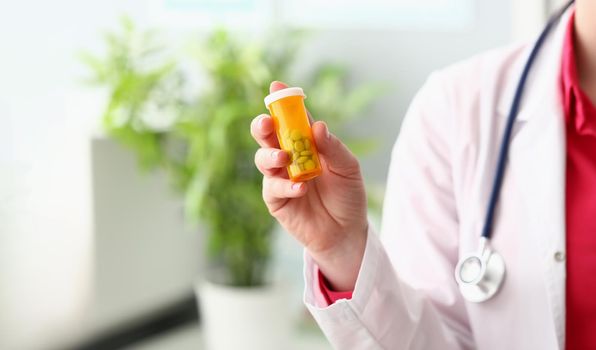 Female doctor hand holding medical pills or pill jar mockup. Medicine pharmacy prescription drugs or vitamins concept