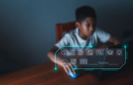 education icon On the background of blurry pictures a boy is staring at a computer monitor. educational concept, educational information search, copy space