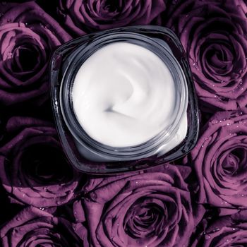 Luxe cosmetics, branding and anti-age concept - Face cream skin moisturizer on purple roses flowers, luxury skincare cosmetic product on floral background as beauty brand holiday flatlay design