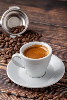 Fresh espresso coffee together decorated with coffee beans on wooden table