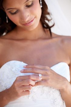 Admiring her diamond. Closeup of a young bride wearing her wedding ring
