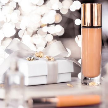 Cosmetic branding, Christmas glitter and girly blog concept - Holiday make-up foundation base, concealer and white gift box, luxury cosmetics present and blank label products for beauty brand design