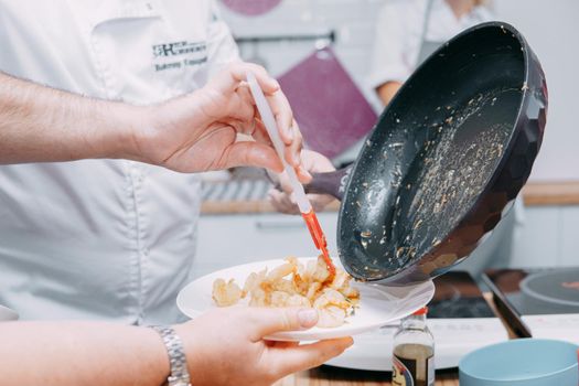 Preparing Sarsuella in a cooking mater class. Shrimp close-up. Cooking at home, home-cooked food. prawns in a pan