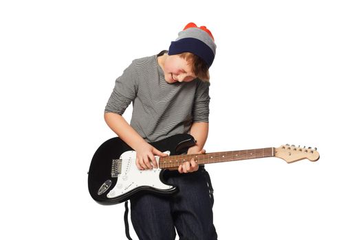 Perfecting his tune. A teenage boy playing a n electric guitar