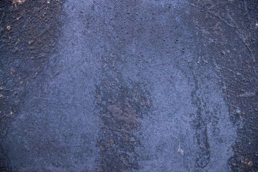 Old metal surface covered black ash  abstract background texture
