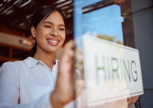 Hiring, recruitment and coffee shop with a woman small business owner hanging a sign in her window. Cafe, startup and management with a female entrepreneur ready to interview staff for a job opening.