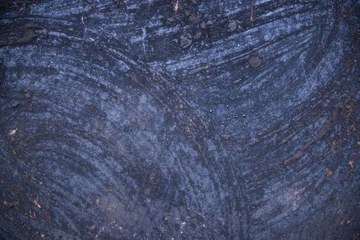 Old metal surface covered black ash  abstract background texture