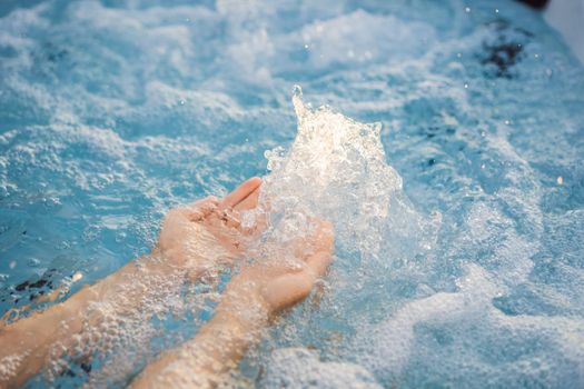 Portrait of young carefree happy smiling woman relaxing at hot tub during enjoying happy traveling moment vacation life against the background of green big mountains.
