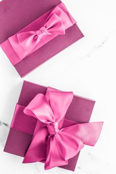 Birthday, wedding and girly branding concept - Pink gift box with silk bow on marble background, girl baby shower present and glamour fashion gift for luxury beauty brand, holiday flatlay art design