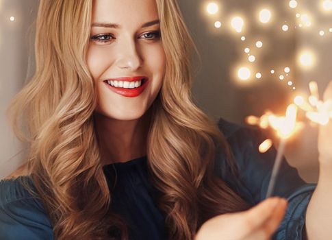 Holiday magic, Christmas and New Year celebration, happy woman with sparklers, portrait