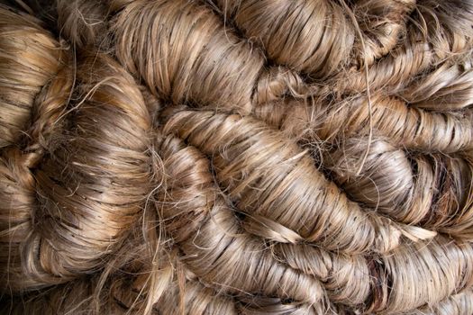 A thick bundle of Golden jute fiber Texture Background