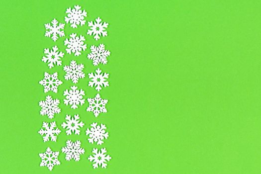 Top view of white snowflakes on colorful background. Winter weather concept with copy space. Merry Christmas concept.