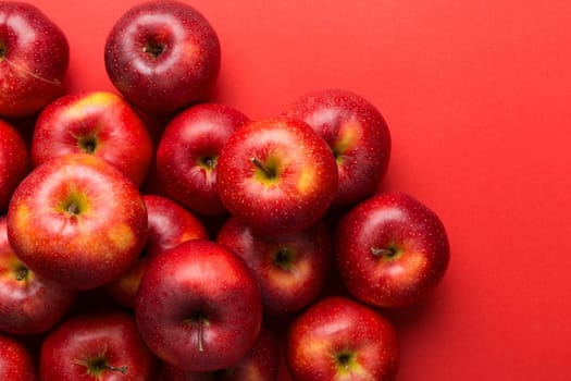 Many red apples on colored background, top view. Autumn pattern with fresh apple above view with copy space for design or text.