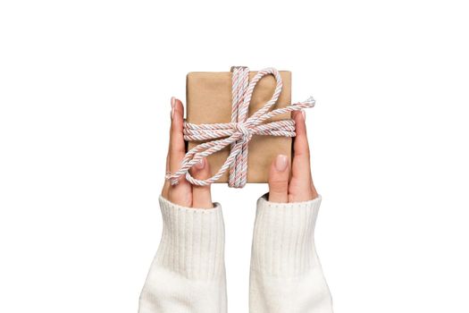 woman hands holding gift wrapped and decorated with pink bow isolated on white.