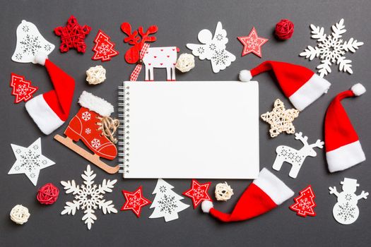 Top view of notebook. New Year decorations on black background. Merry Christmas concept.