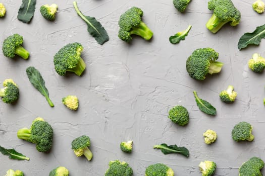 Flat lay composition with fresh green broccoli frame eith copy space on light background.