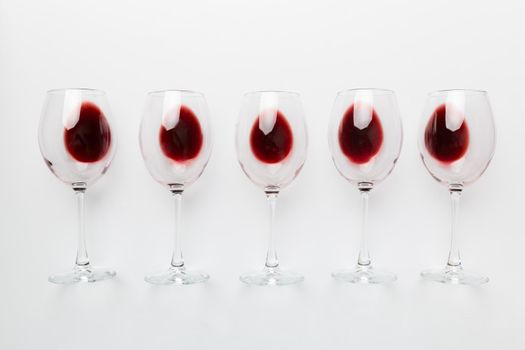 Many glasses of red wine at wine tasting. Concept of red wine on colored background. Top view, flat lay design.