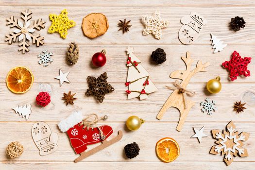 Top view of Christmas toys on wooden background. New Year ornament. Holiday concept.