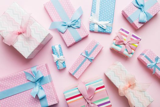 A lot of Christmas gift boxes in colored paper decorated on table, Top view close up. Many present New Year gift.