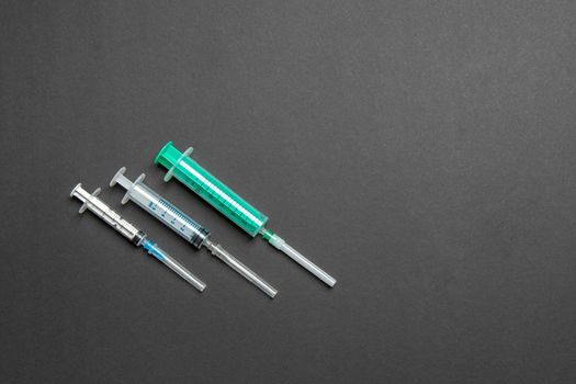 Top view of different syringes for injection on colorful background. Medical equipment concept with copy space.