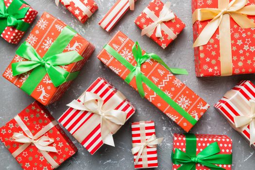 A lot of Christmas gift boxes in colored paper decorated on table, Top view close up. Many present New Year gift.