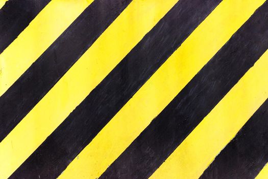 Safety stripes on construction site, Black and yellow Under construction sign over a grunge texture, top view