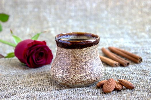 Composition with coffee, rose and cinnamon sticks.