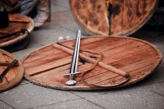 Wood shield and sword. Weapons of the Medieval Warrior. Reconstruction of medieval military equipment.