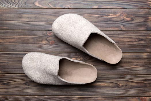 Warm winter women woolen slippers on the floor. Copy space for text.