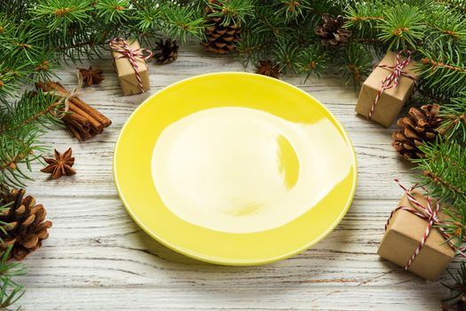 Perspective view. Empty plate round ceramic on wooden christmas background. holiday dinner dish concept with new year decor.