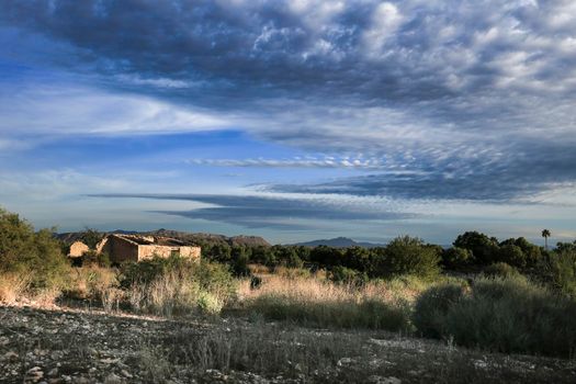 Abandoned house in the countryside under beautiful sky in Spain