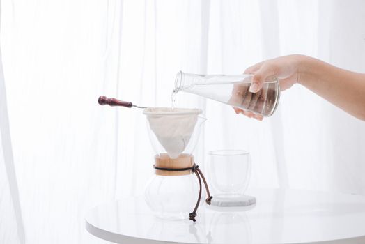 Pouring Water to the Coffee Pot on White Wall and White Table, Manual Brew, Hand Drip Coffee