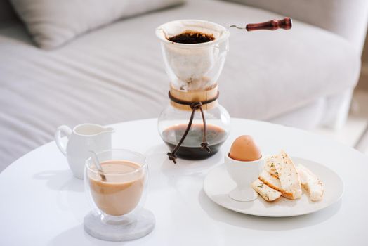 Serving hot coffee in the living room of his home in the morning