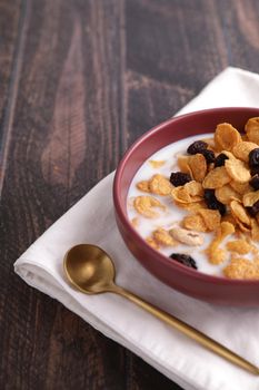 Cereal dessert with corn oat and dry fruits isolated in wood background