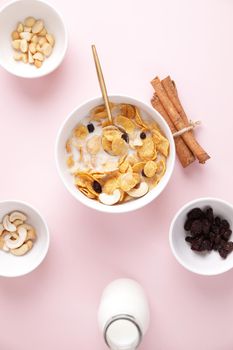 Cereal dessert with corn oat and dry fruits isolated in pink background