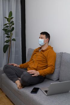 young man exercising at home sitting on couch. High quality photo