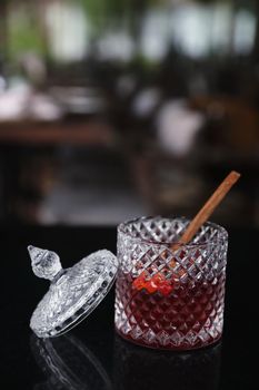 Pink Cocktail glass with ice at a bar counter