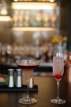 cocktails in glasses on bar counter in pup or restaurant