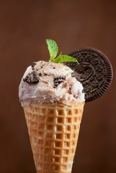 Sweet homemade ice cream with cookies in cone, selective focus