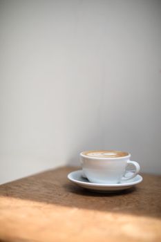 cappuccino or Latte art coffee made from milk on the wood table in coffee shop