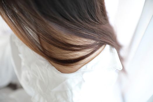 Close up girl face and hair with hair in white bedroom