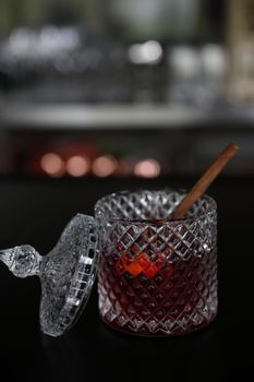 Pink Cocktail glass with ice at a bar counter