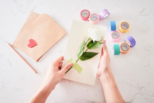 Making decorations or greeting card. Paper strips, flower, scissors. Handmade crafts on holiday: Birthday, Mother's or Father's Day, March 8, Wedding. 