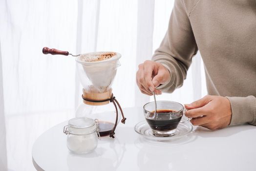 Young man enjoying coffee and breakfast at a cafe