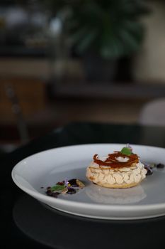 Chocolate dessert cake with berry sauce and almond with decorated