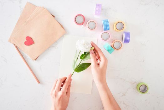 Making decorations or greeting card. Paper strips, flower, scissors. Handmade crafts on holiday: Birthday, Mother's or Father's Day, March 8, Wedding. 