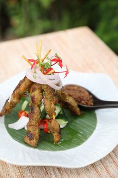 Chicken Satay on dark brown table street food appetizer