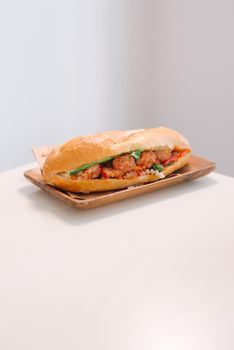 Banh Mi Xiu Mai is a popular pork ball sandwich with tomato sauce in Vietnam