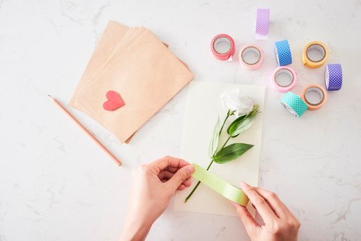 Making decorations or greeting card. Paper strips, flower, scissors. Handmade crafts on holiday: Birthday, Mother's or Father's Day, March 8, Wedding. 