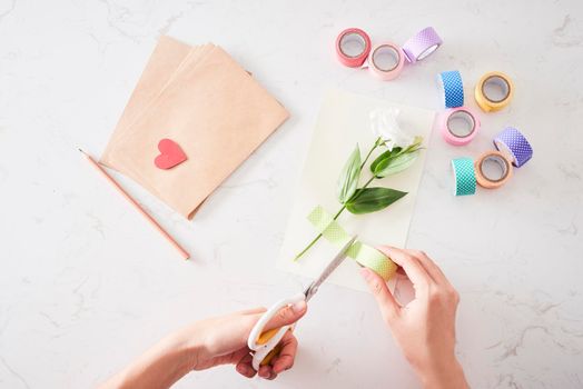 Making decorations or greeting card. Paper strips, flower, scissors. Handmade crafts on holiday: Birthday, Mother's or Father's Day, March 8, Wedding. 